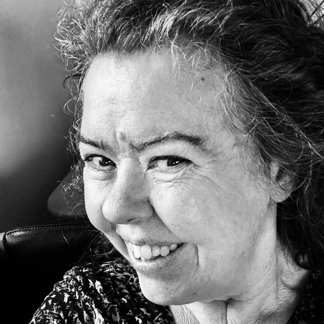 Close-up of older woman smiling in a black and white photo